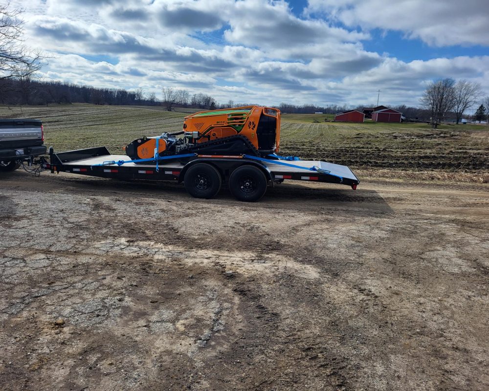 Green Climber remote-controlled slope mower clearing brush in Northwest Indiana